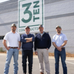 Three partners and one founding member of 3TEN Construction standing outside the Charlotte office.